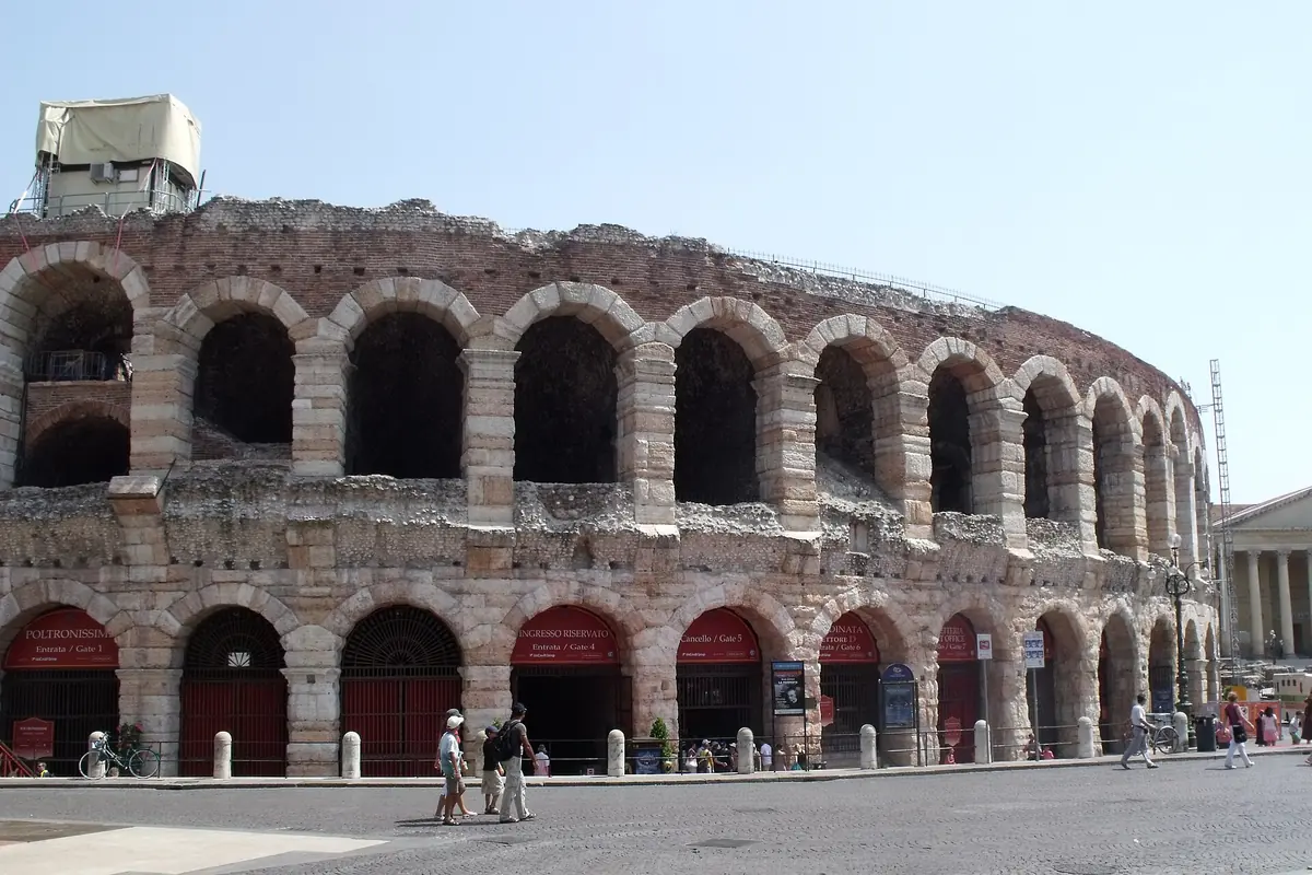 The Verona Arena seen from Piazza Bra, a curved arcade of Roman stone arches